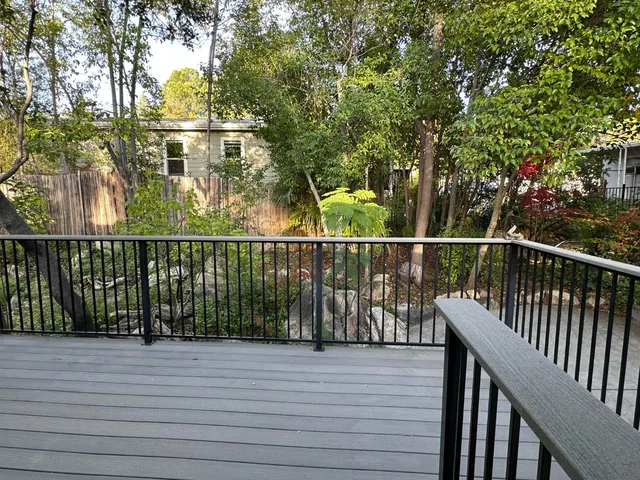 a view of a balcony with refrigerator and wooden floor