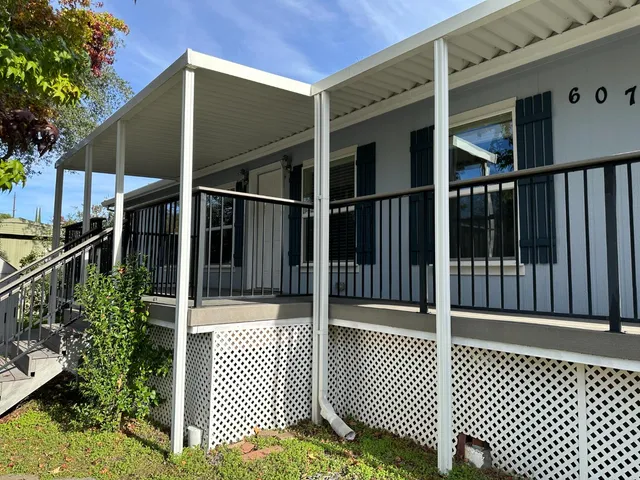 a kitchen with stainless steel appliances granite countertop a sink a stove a refrigerator cabinets and a counter top space