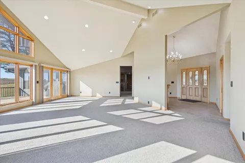 a dining hall with stainless steel appliances granite countertop a refrigerator a sink dishwasher a dining table and chairs with wooden floor