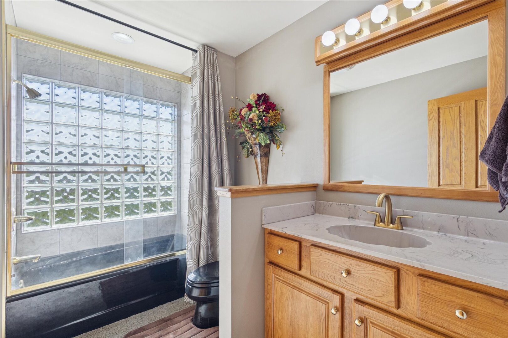 97 Highcrest Court Shannon, IL 61078 - Photo 35 of 58 a bathroom with a granite countertop sink a mirror and a shower