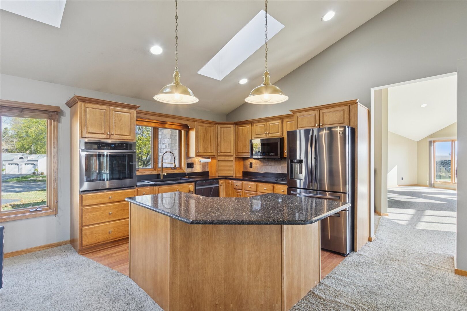 97 Highcrest Court Shannon, IL 61078 - Photo 6 of 58 a kitchen with stainless steel appliances granite countertop a sink a stove and a refrigerator