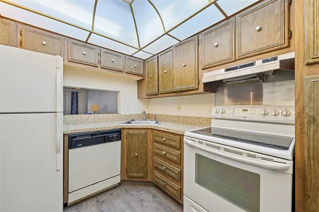 a dining room with furniture a chandelier and wooden floor