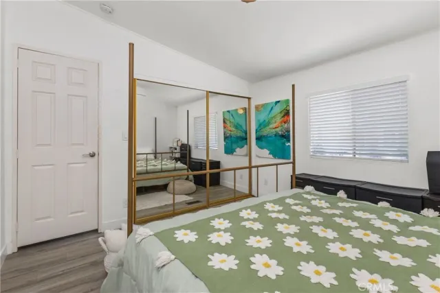 a bedroom with a bed and a large window