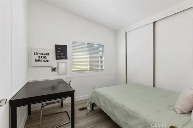 a bedroom with a bed and a desk