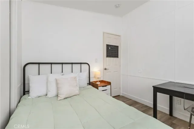 a white bed sitting in a bedroom next to a window