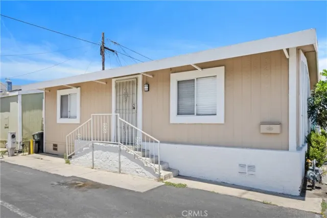 a view of a house with a wooden deck