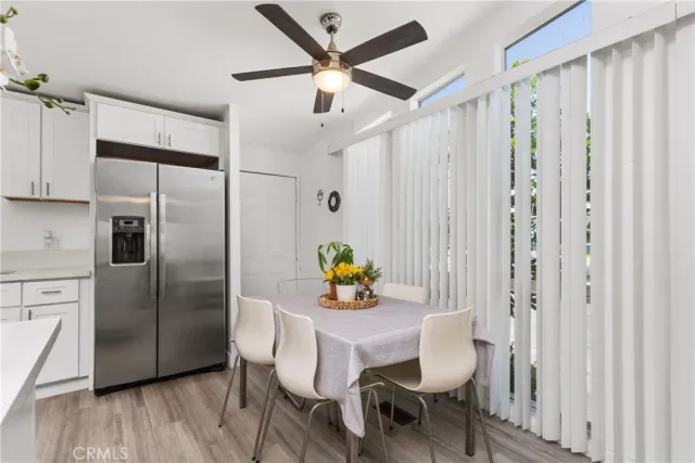 a kitchen with stainless steel appliances a dining table chairs and chandelier