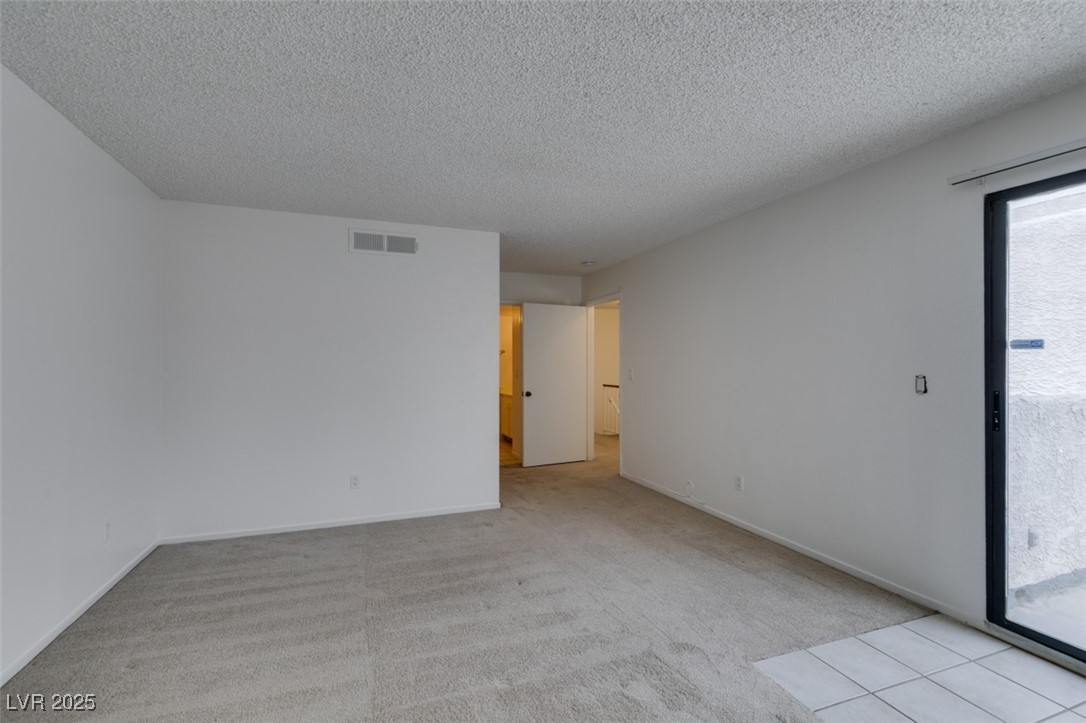 2681 Ruthe Duarte Avenue Las Vegas, NV 89121 - Photo 36 of 43 Unfurnished room featuring visible vents, a textured ceiling, baseboards, and carpet floors