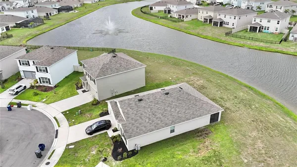 an aerial view of a house with a garden and swimming pool