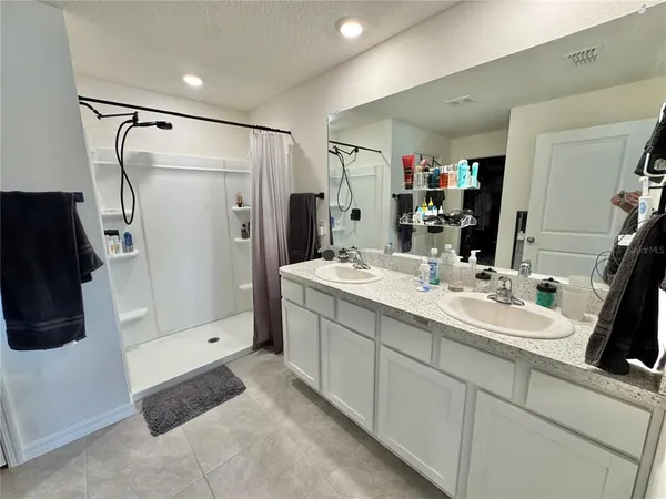 a bathroom with a double vanity sink a and mirror