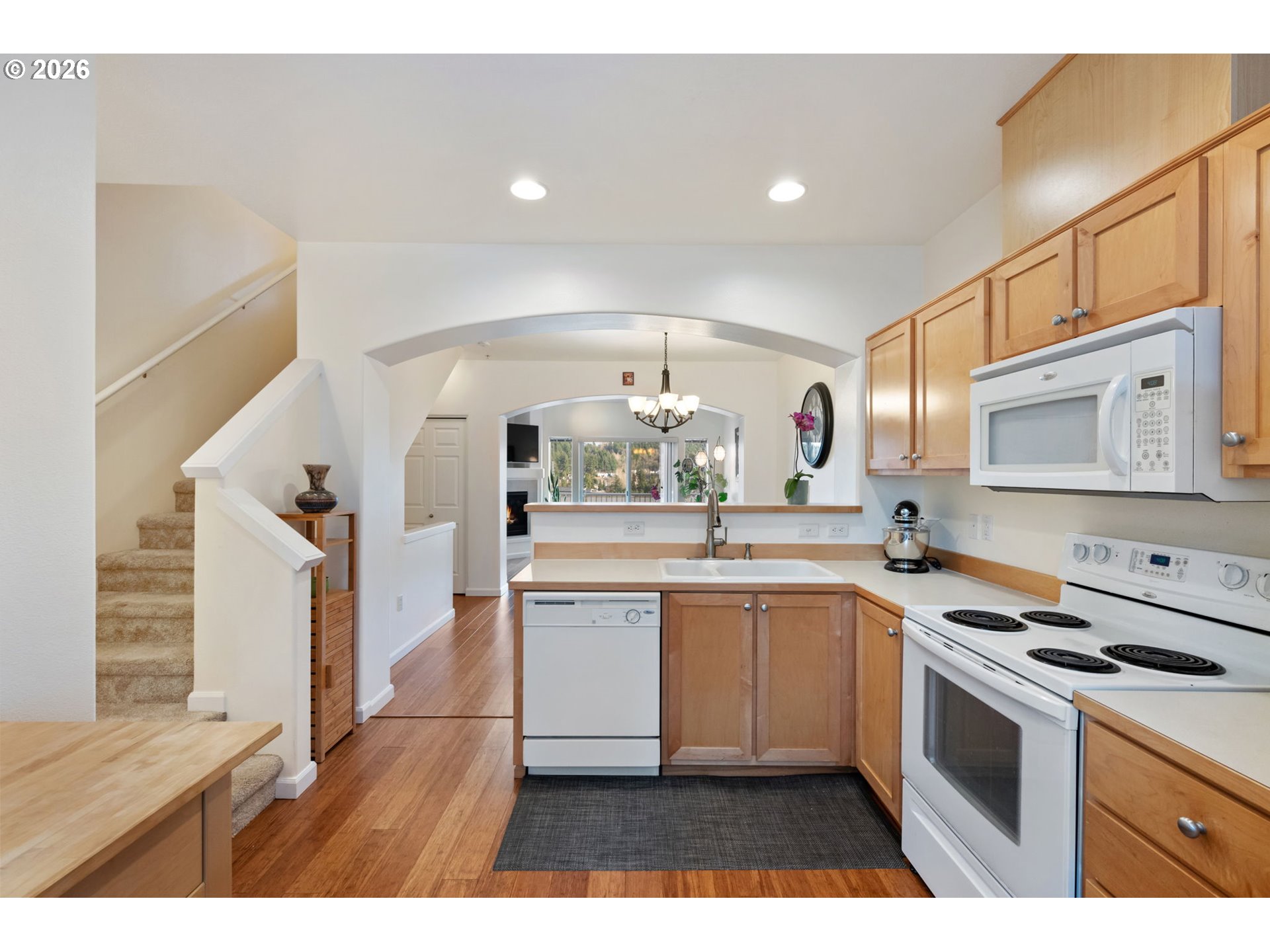 15465 Southwest Sparrow Loop, Unit 102 Beaverton, OR 97007 - Photo 12 of 44 a kitchen with a sink stove and cabinets