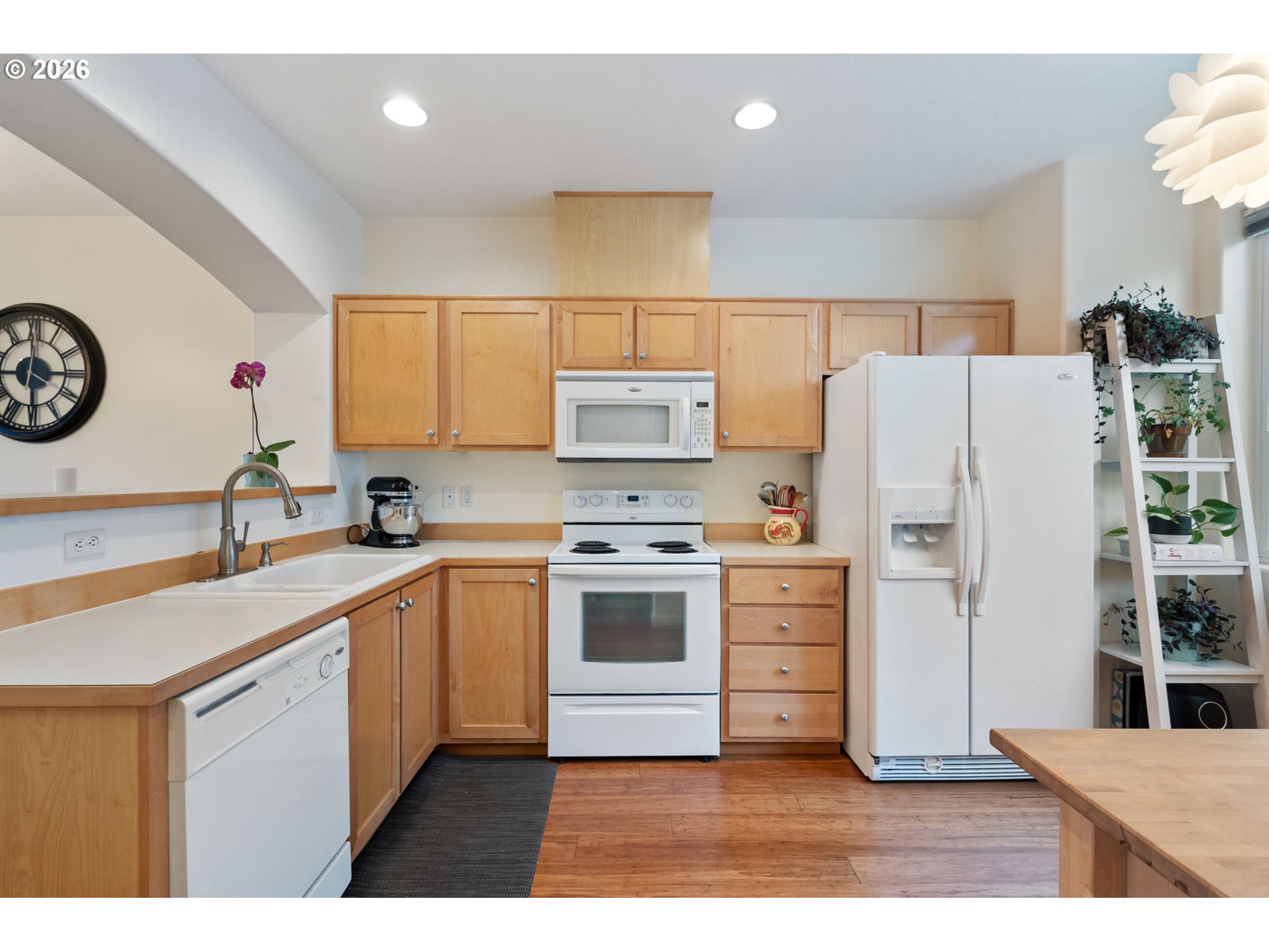 15465 Southwest Sparrow Loop, Unit 102 Beaverton, OR 97007 - Photo 13 of 44 a kitchen with a white stove top oven and refrigerator