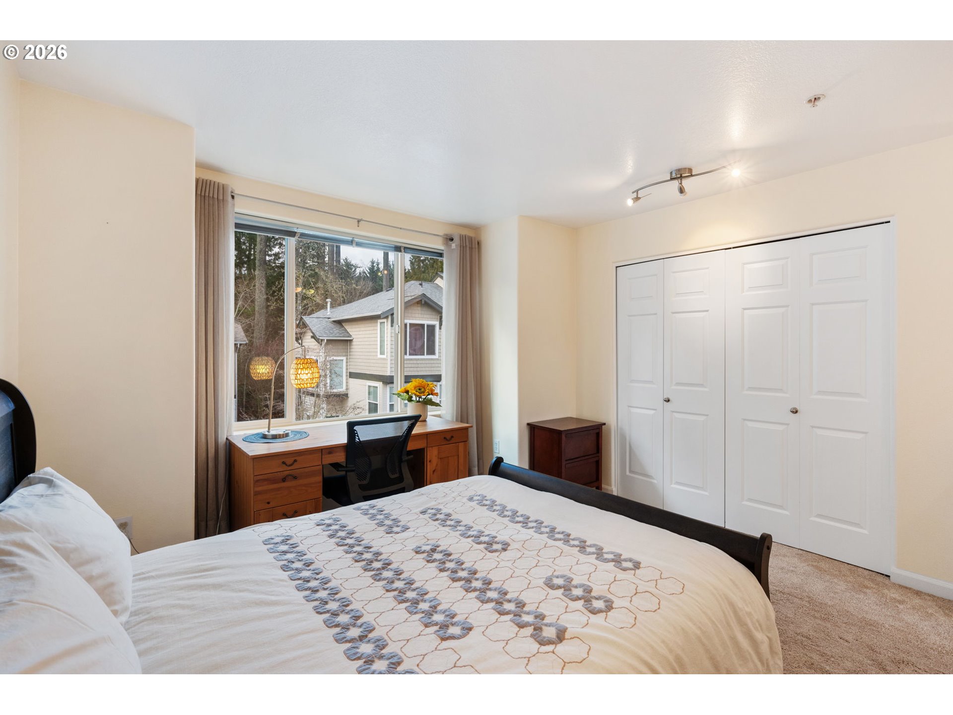 15465 Southwest Sparrow Loop, Unit 102 Beaverton, OR 97007 - Photo 18 of 44 a bedroom with a bed and wooden floor