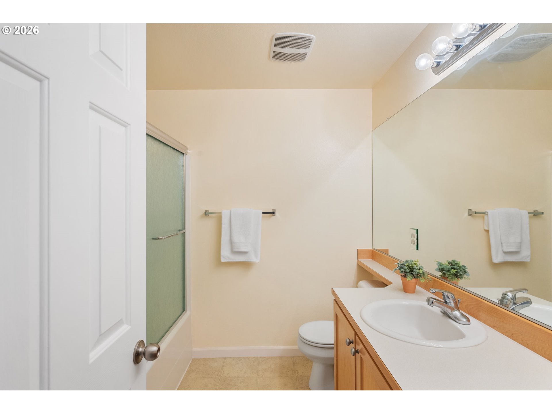 15465 Southwest Sparrow Loop, Unit 102 Beaverton, OR 97007 - Photo 20 of 44 a bathroom with a sink toilet and mirror