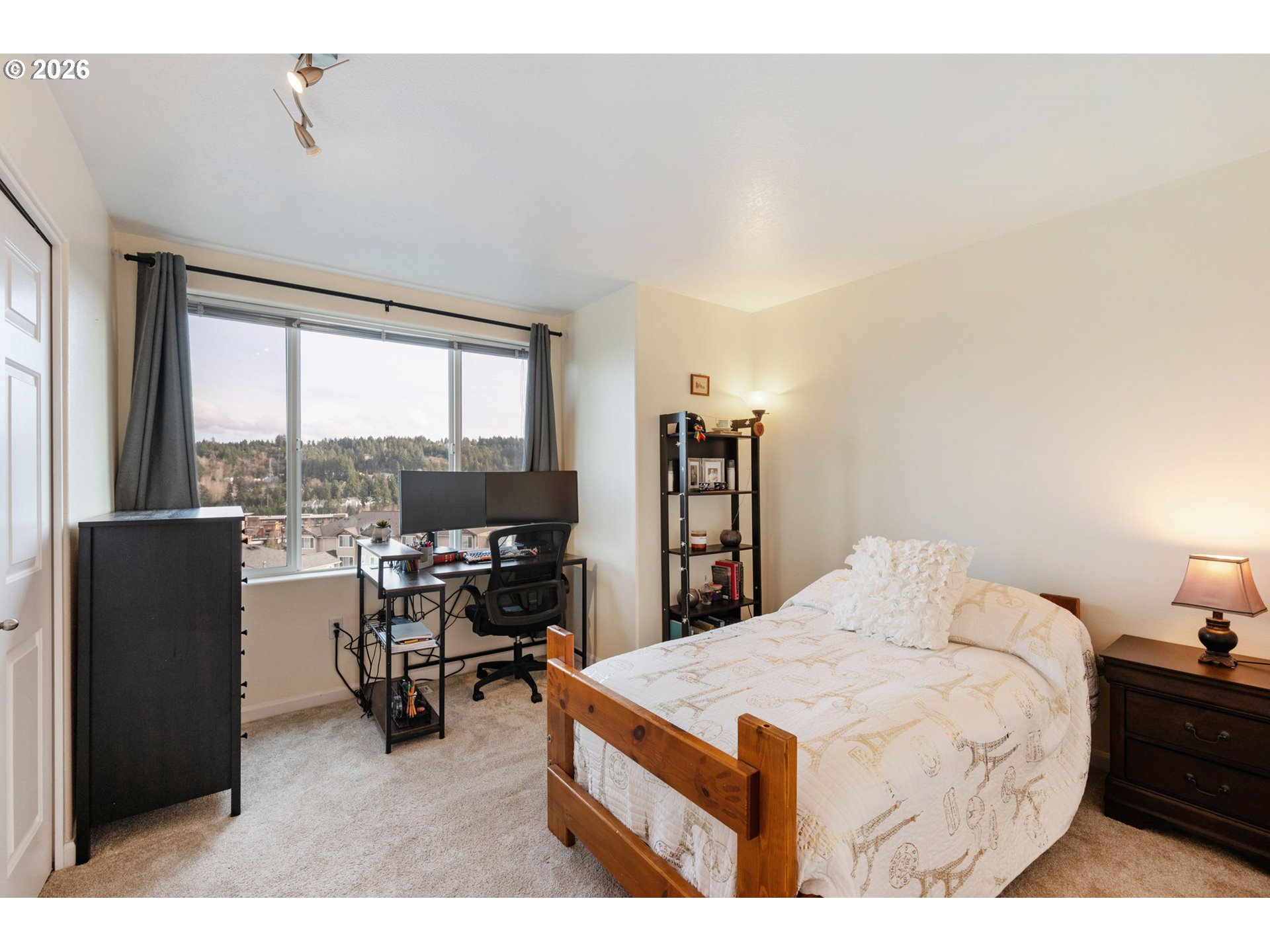 15465 Southwest Sparrow Loop, Unit 102 Beaverton, OR 97007 - Photo 21 of 44 a bedroom with a bed and a large window
