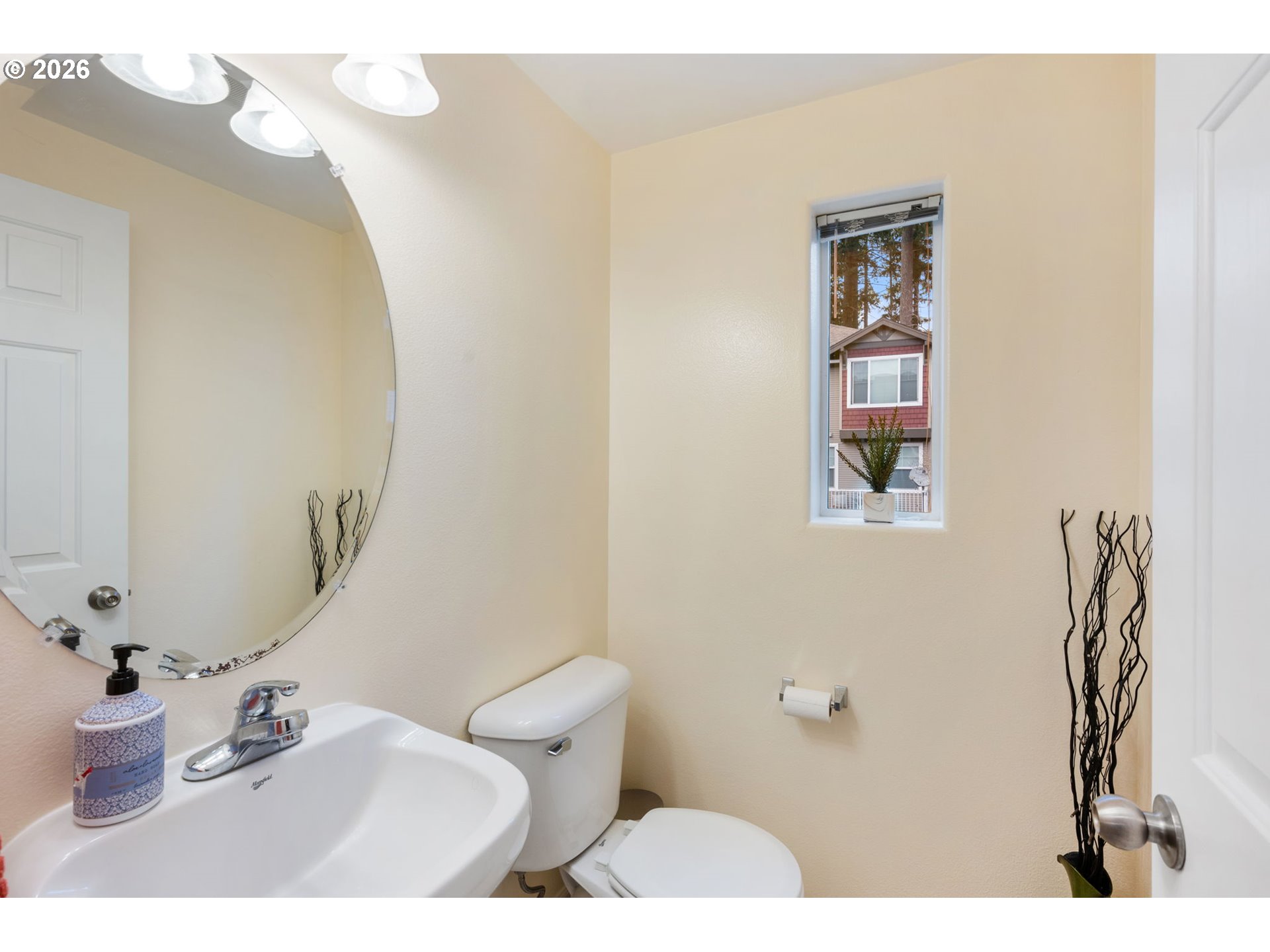 15465 Southwest Sparrow Loop, Unit 102 Beaverton, OR 97007 - Photo 24 of 44 a bathroom with a sink a toilet and mirror