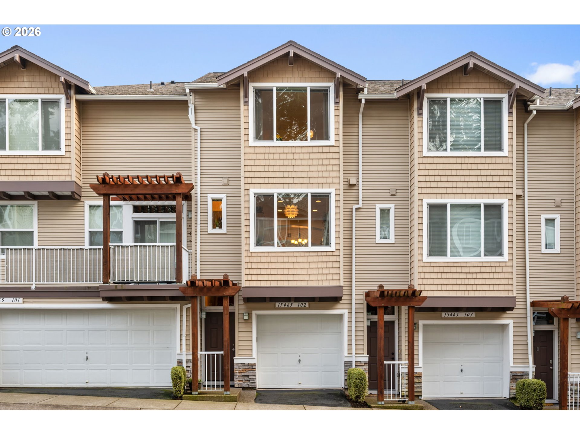15465 Southwest Sparrow Loop, Unit 102 Beaverton, OR 97007 - Photo 30 of 44 a front view of a house with a garage