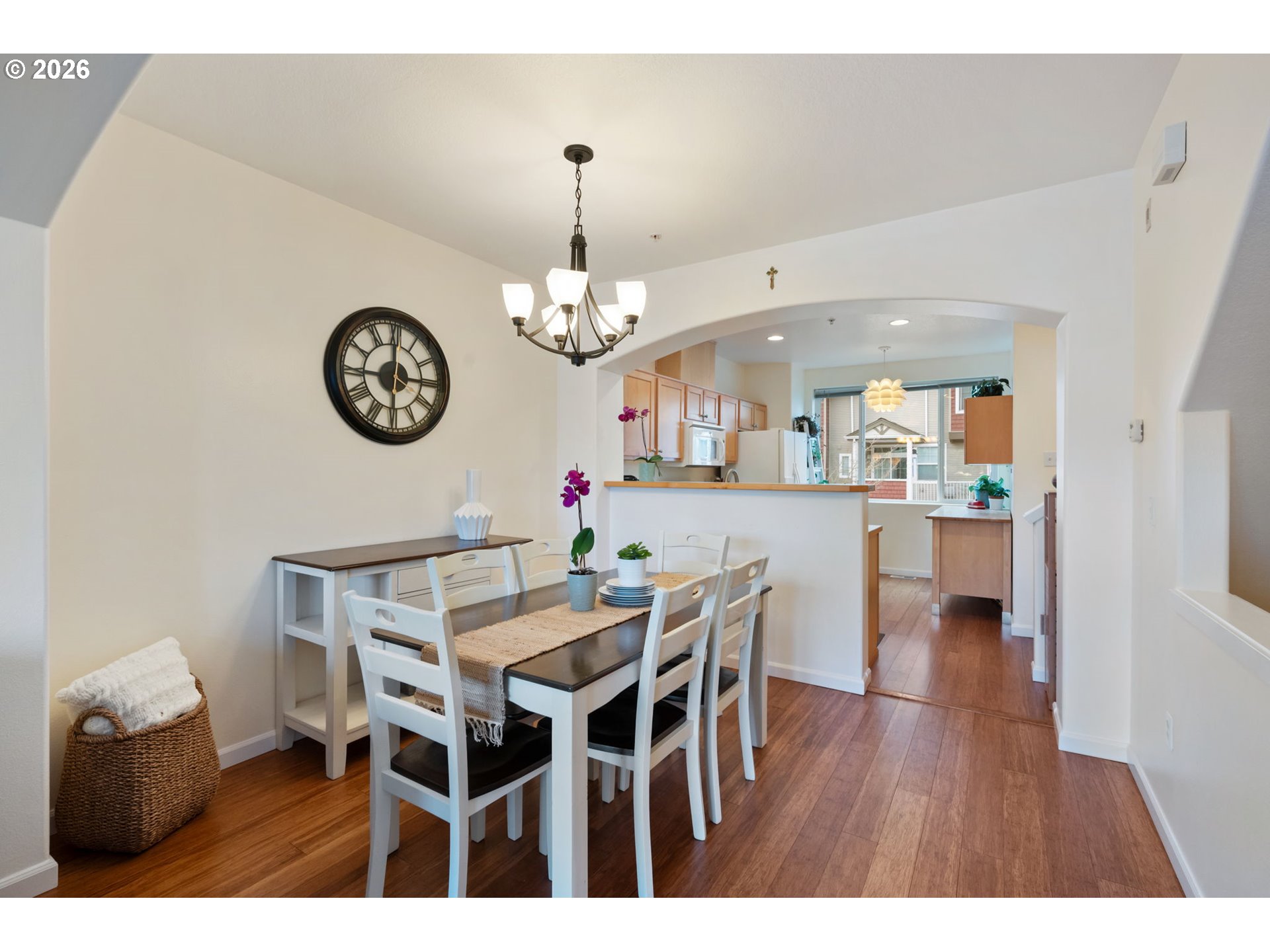 15465 Southwest Sparrow Loop, Unit 102 Beaverton, OR 97007 - Photo 10 of 44 a view of a dining room and a wooden table and chairs