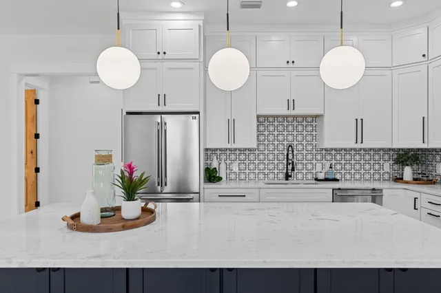 a living room with furniture ceiling fan and a large window