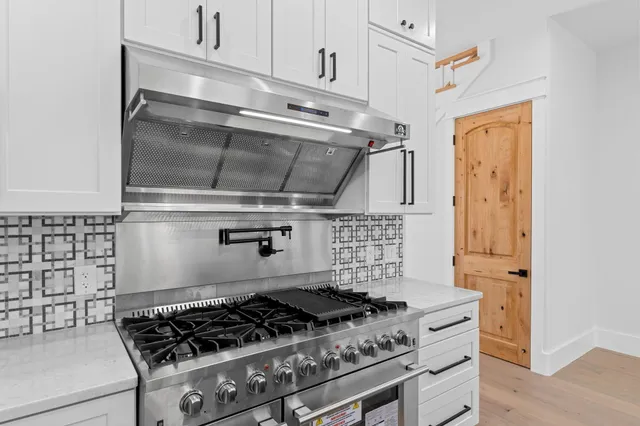 a living room with furniture a flat screen tv and a large window