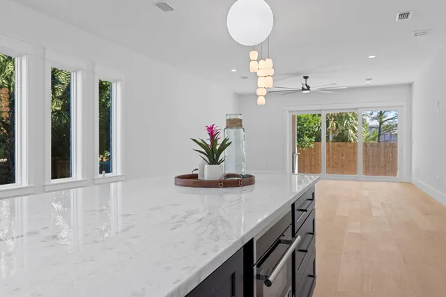 a view of a livingroom with a ceiling fan and wooden floor
