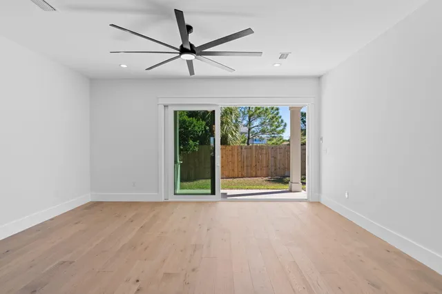 a living room with furniture wooden floor and a flat screen tv