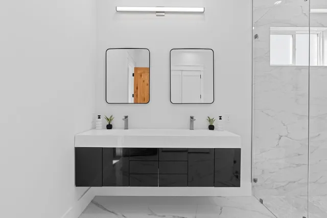 an empty room with wooden floor and fan