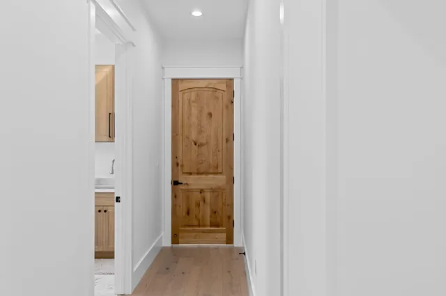 an empty room with windows and ceiling fan