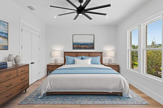 a spacious bedroom with a bed and a window