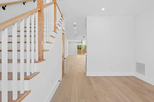 a kitchen with kitchen island granite countertop a sink cabinets and stainless steel appliances