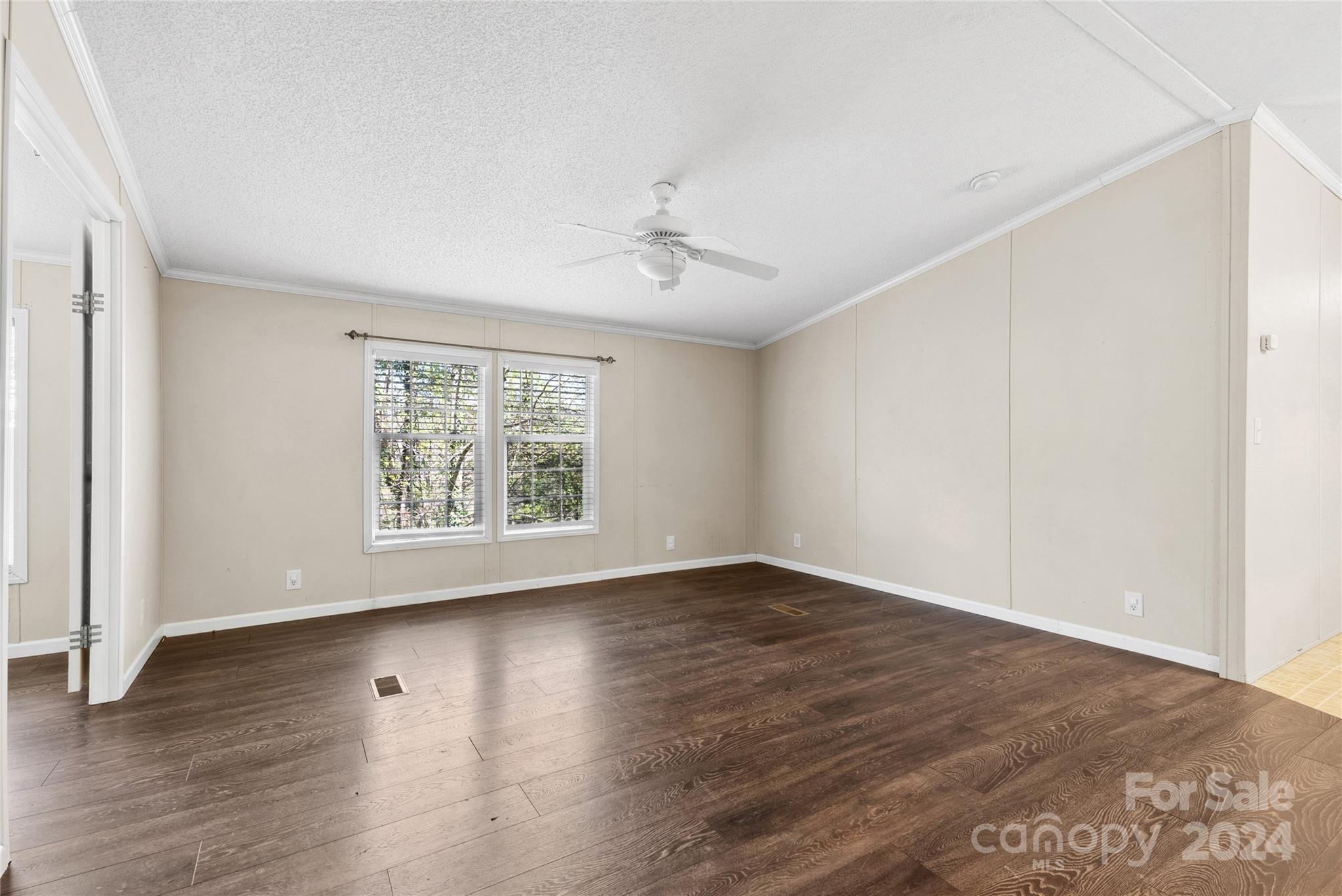 3262 Windswept Ridge Road Marshall, NC 28753 - Photo 17 of 39 a view of an empty room with wooden floor and a window
