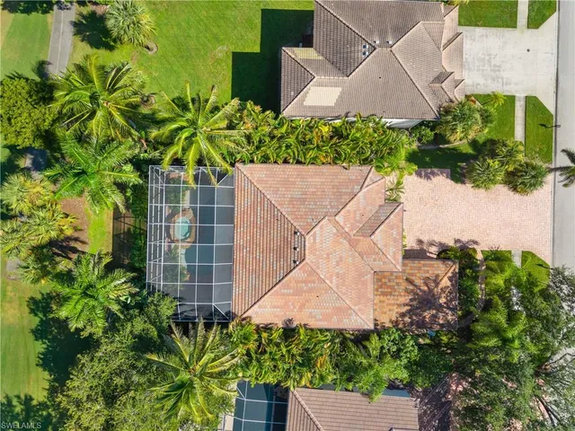 an aerial view of a house with a yard and potted plants