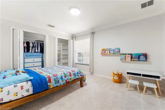 a bedroom with a bed and a desk