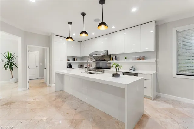 a very nice looking room with a large window and chandelier