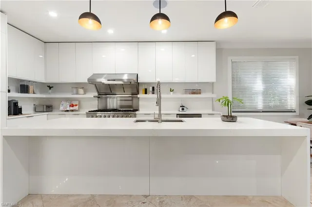 a kitchen with stainless steel appliances a sink and a stove