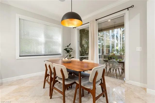 a view of a dining room with furniture and window