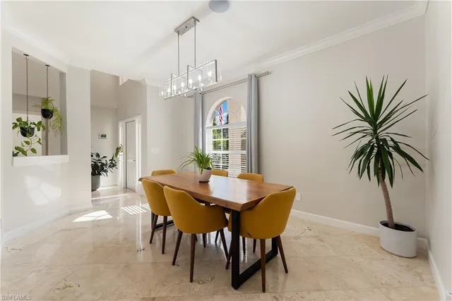 a view of a dining room with furniture and a chandelier