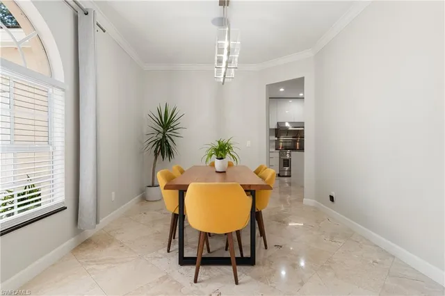 a view of a dining room with furniture and a chandelier