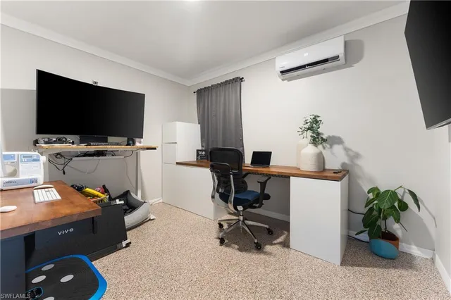 a view of a workspace with furniture and a potted plant
