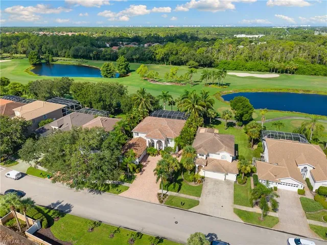 an aerial view of a house with a garden and lake view