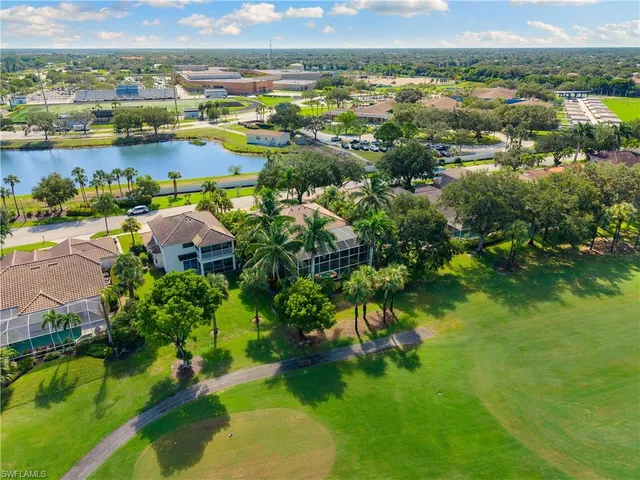 an aerial view of residential houses with outdoor space and lake view