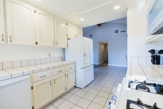 620 East Wilson Avenue Ridgecrest, CA 93555 - Photo 10 of 30 a kitchen with white cabinets and white appliances