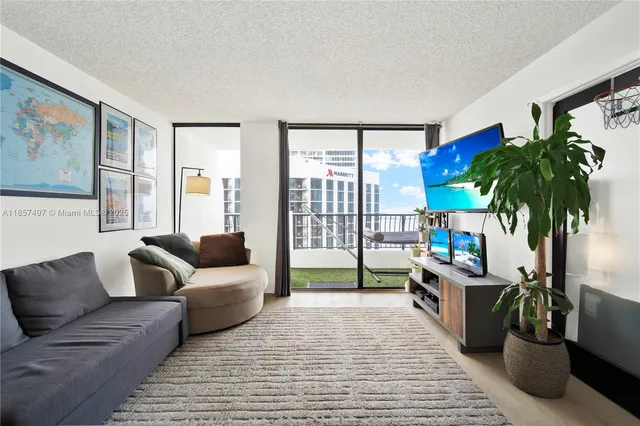a living room with furniture floor to ceiling window and potted plant