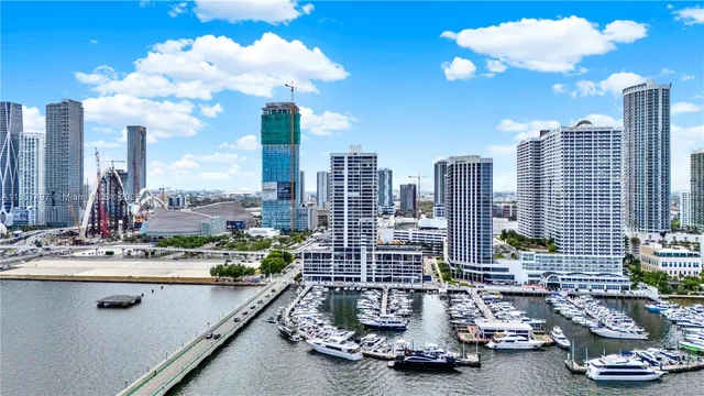 a room with gym equipment and large windows