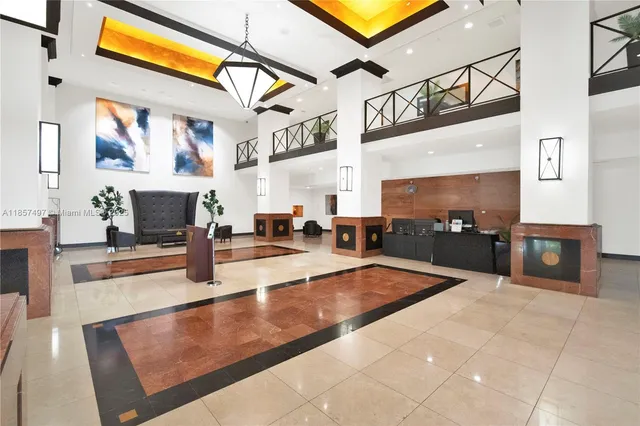 a lobby with furniture and a fireplace