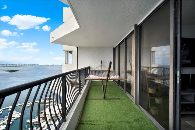 a view of a balcony with floor to ceiling windows