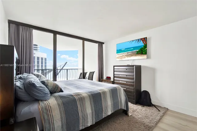 a bedroom with a bed and a large window