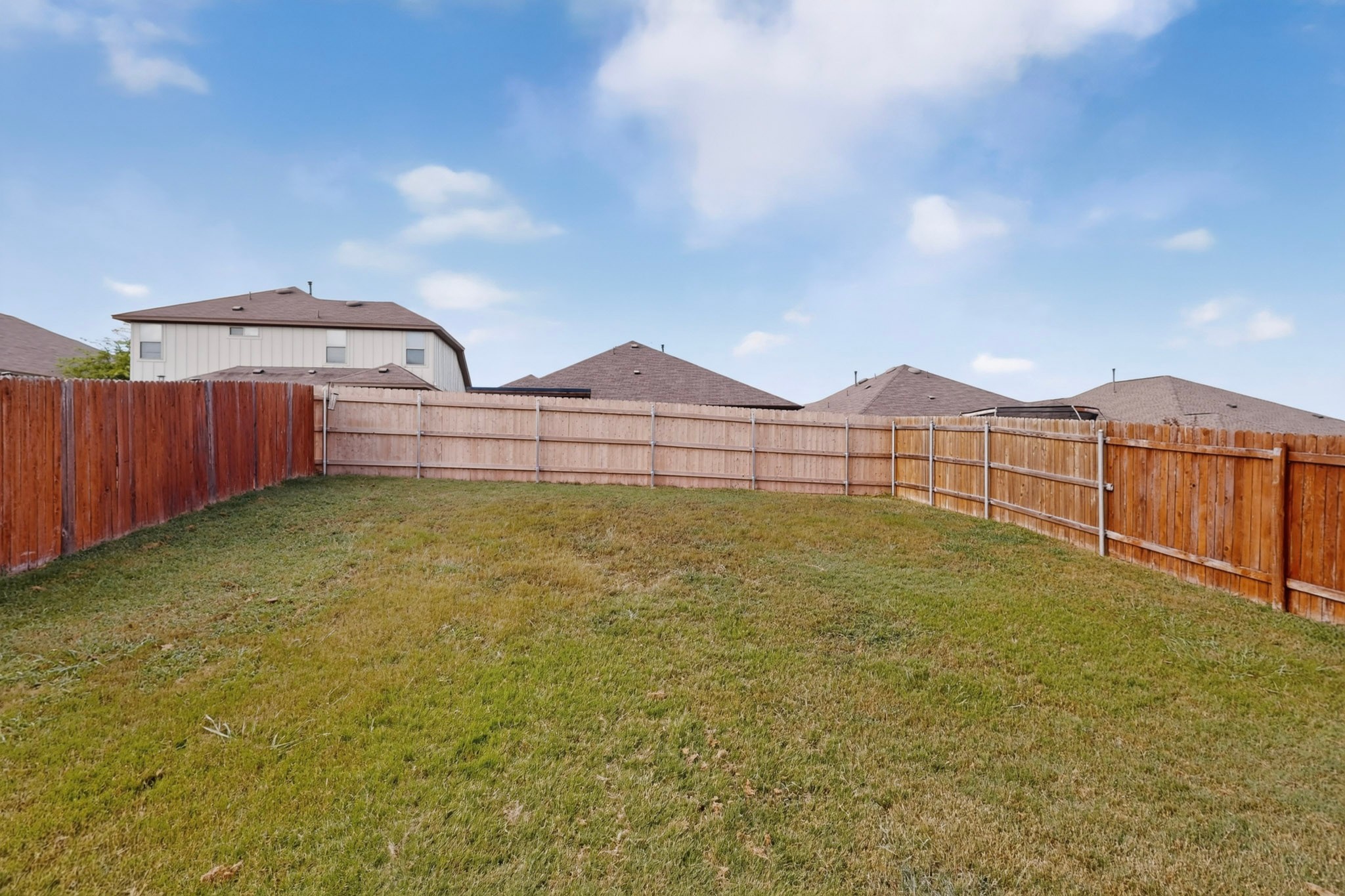 132 Wapiti Road Buda, TX 78610 - Photo 28 of 31 A spacious, enclosed backyard offers ample room for outdoor recreation and privacy.
