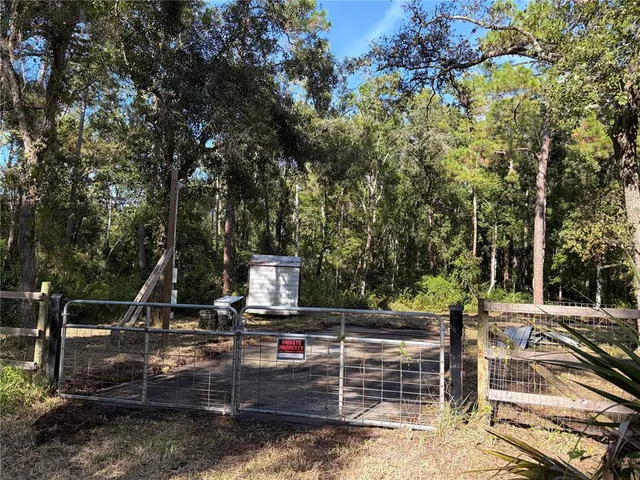 a view of a chairs and fire pit in the backyard