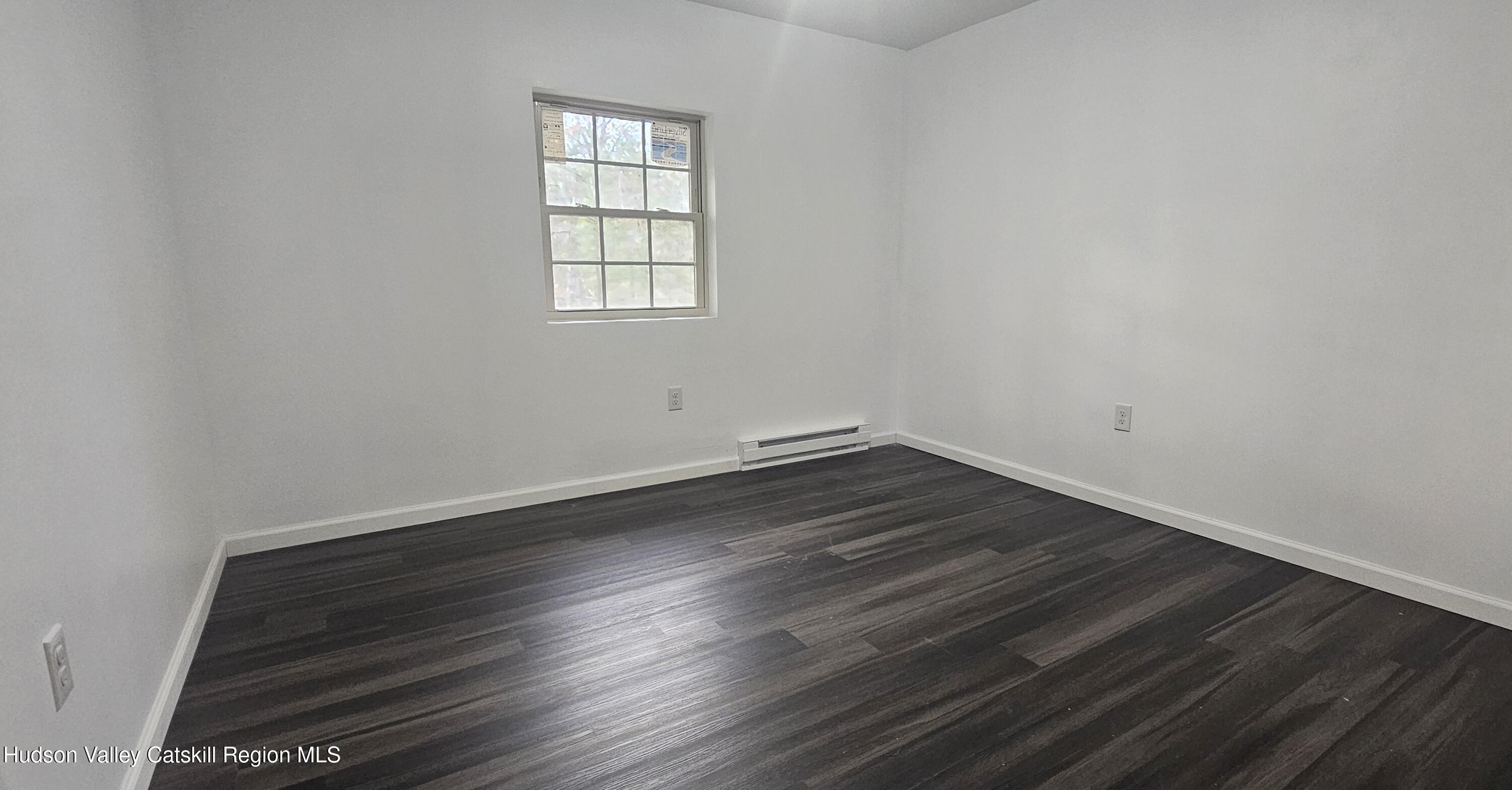 374 North Ridge Road Hannacroix, NY 12087 - Photo 11 of 24 an empty room with wooden floor and windows
